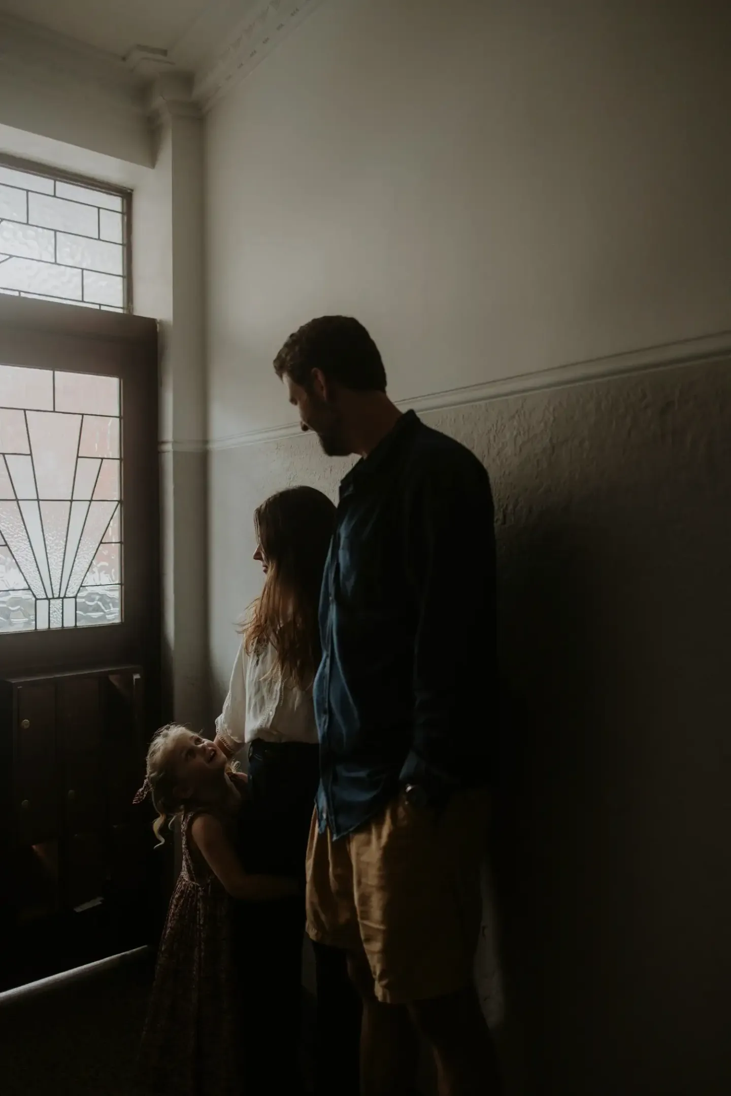Family gathered beside a window in soft indoor light